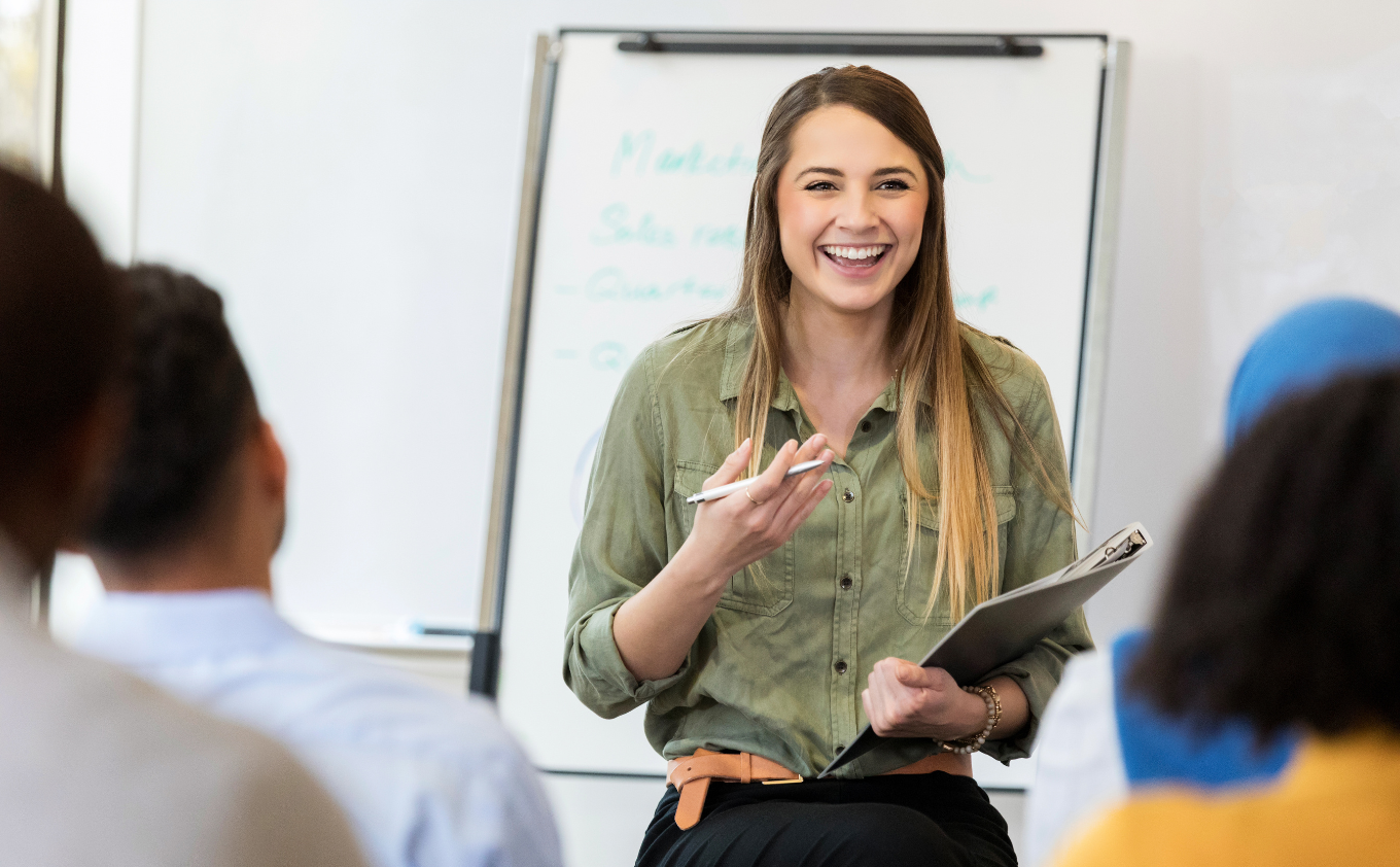 A teacher enjoying presenting a training to a group of other educators